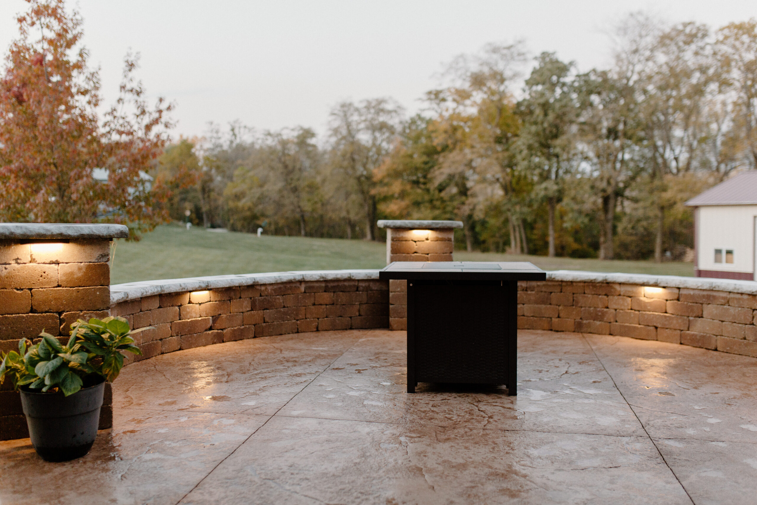 featured lighting on a firepit with a stone bench seating install on a landscape project in Central Iowa.
