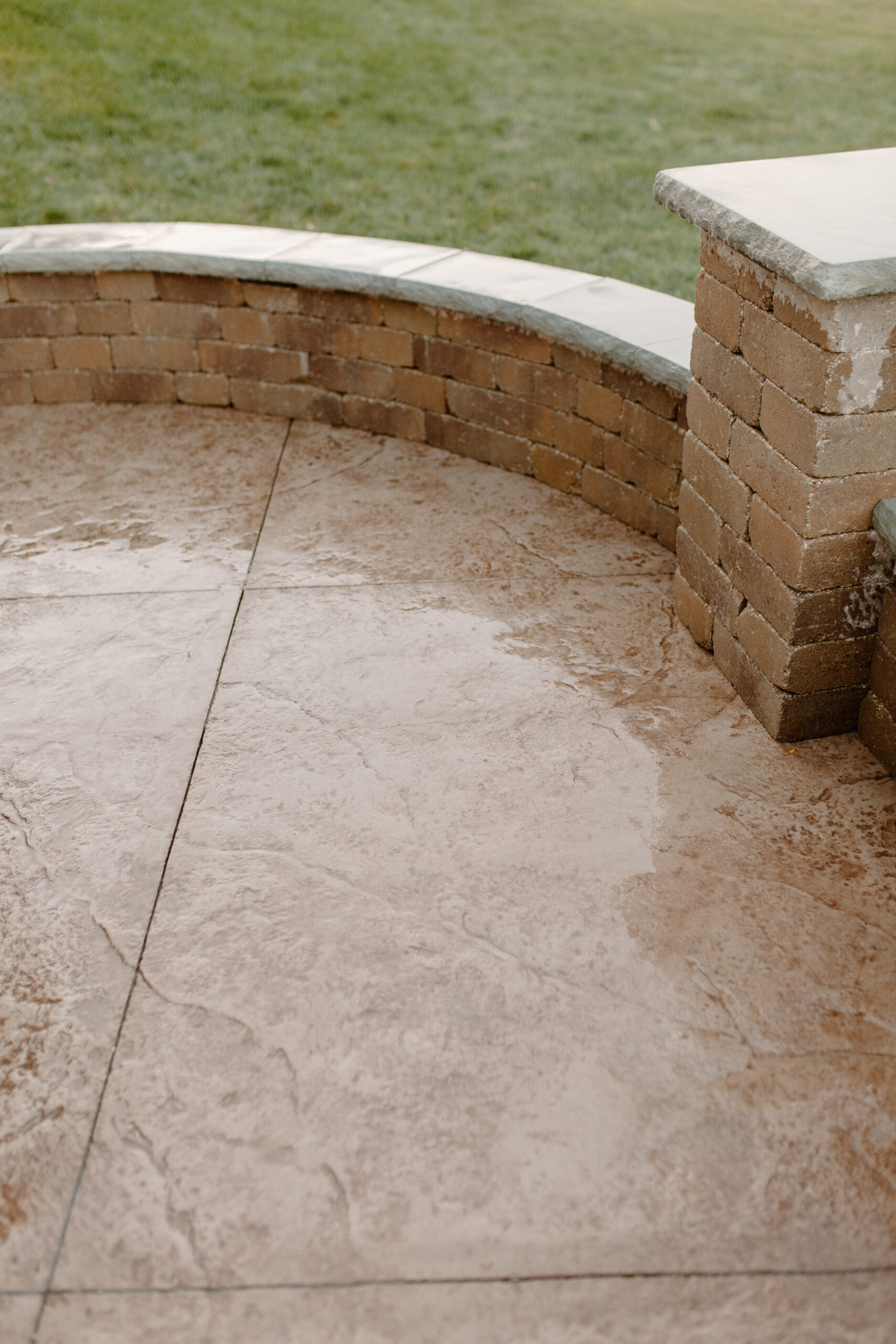 Concrete poured patio along with a stone surround seating feature. Des Moines, Iowa
