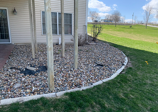 Before just a rock bed with pillars supporting the deck above- Creative Nature Landscape Design and Installation