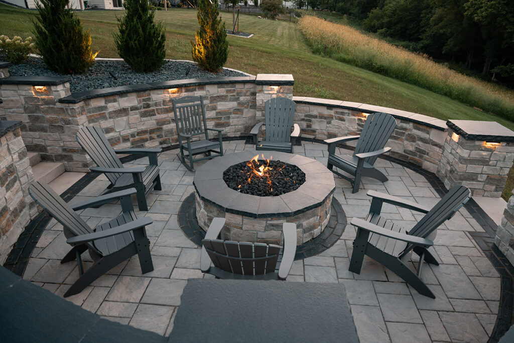 Outdoor Patio with firepit all in grey stone with Adirondack chairs