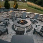 Outdoor Patio with firepit all in grey stone with Adirondack chairs
